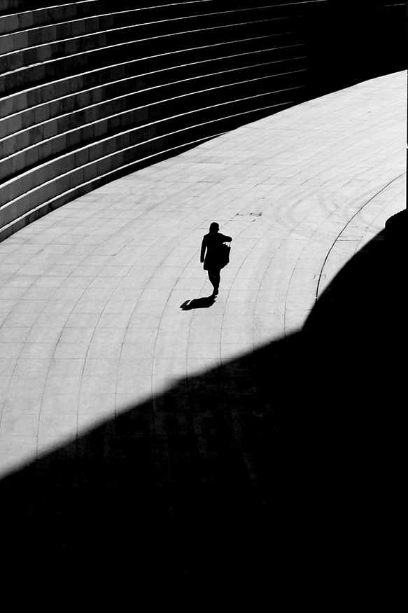 Silhouetted person walking from a distance (black & white)