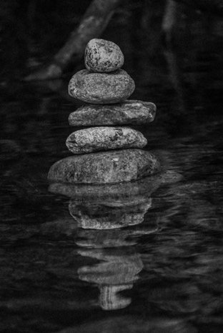 A stone tower built in a stream (black & white)