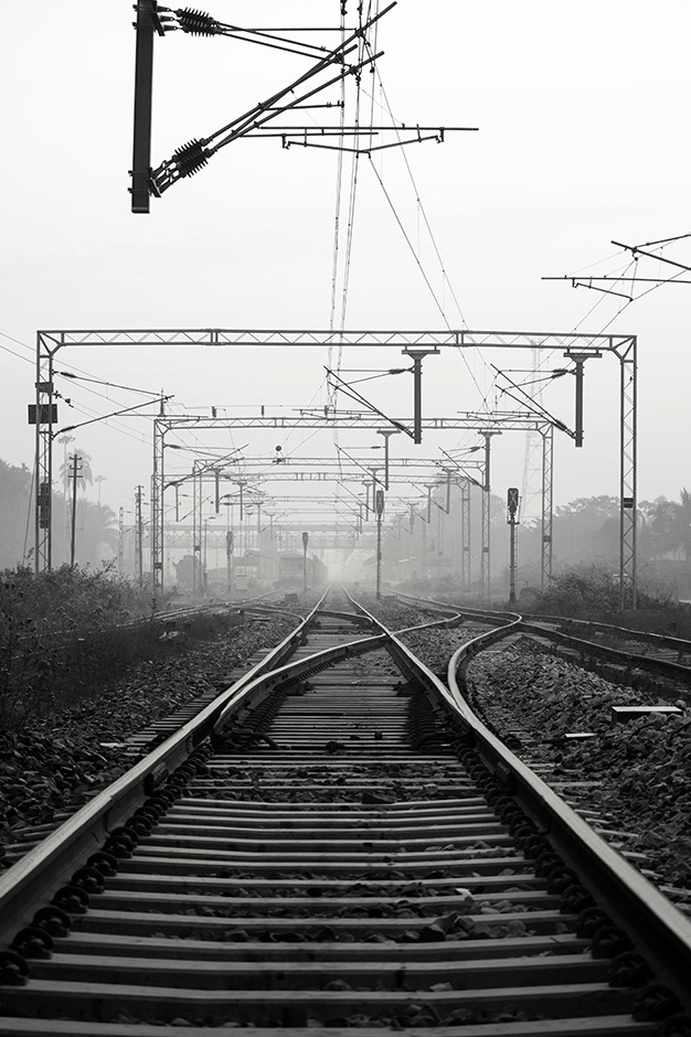 A train track stretches into the distance (black & white)