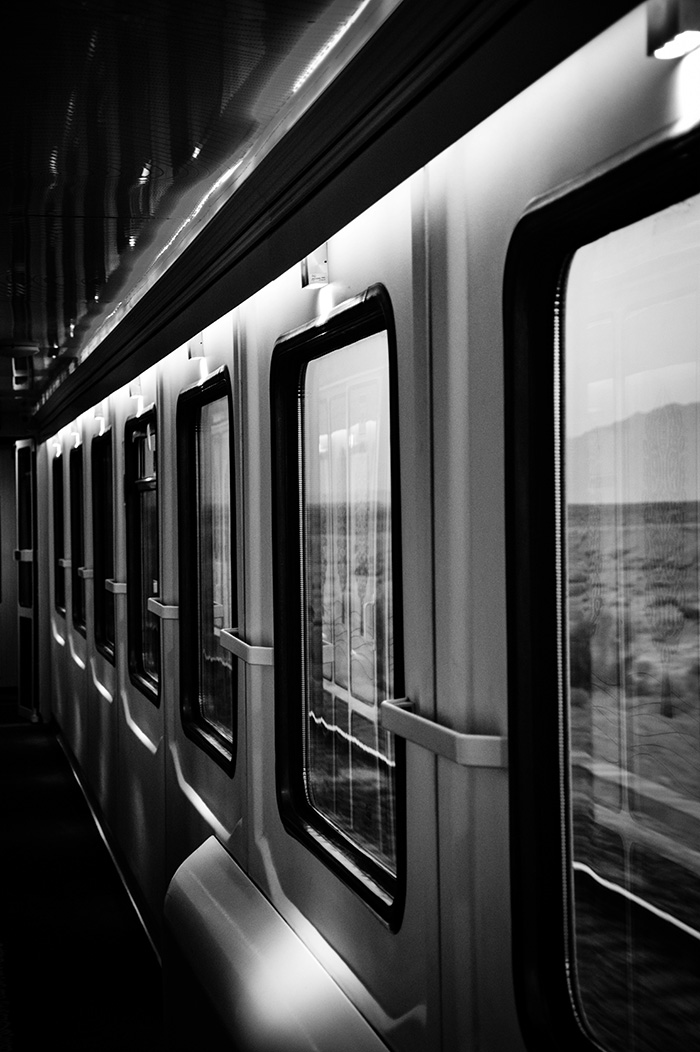 A train speeds past the viewer (black & white)