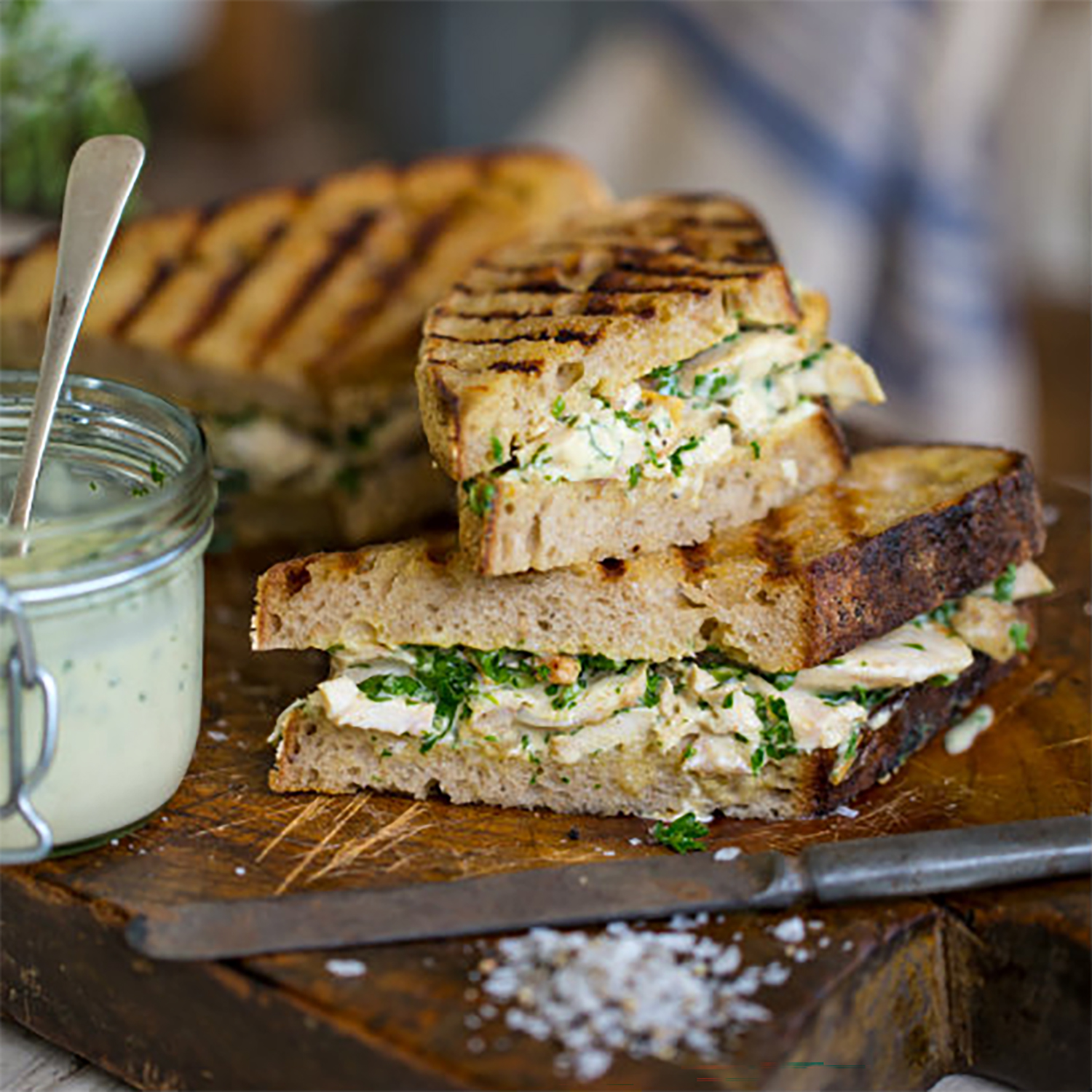 Closeup on a chicken mayo sandwich on a wooden board