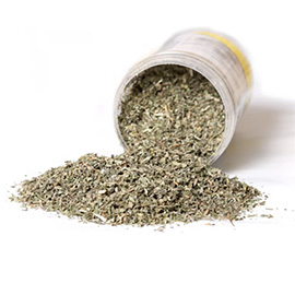 Dried catnip in a storage tube that has fallen on its side so that the contents spill out